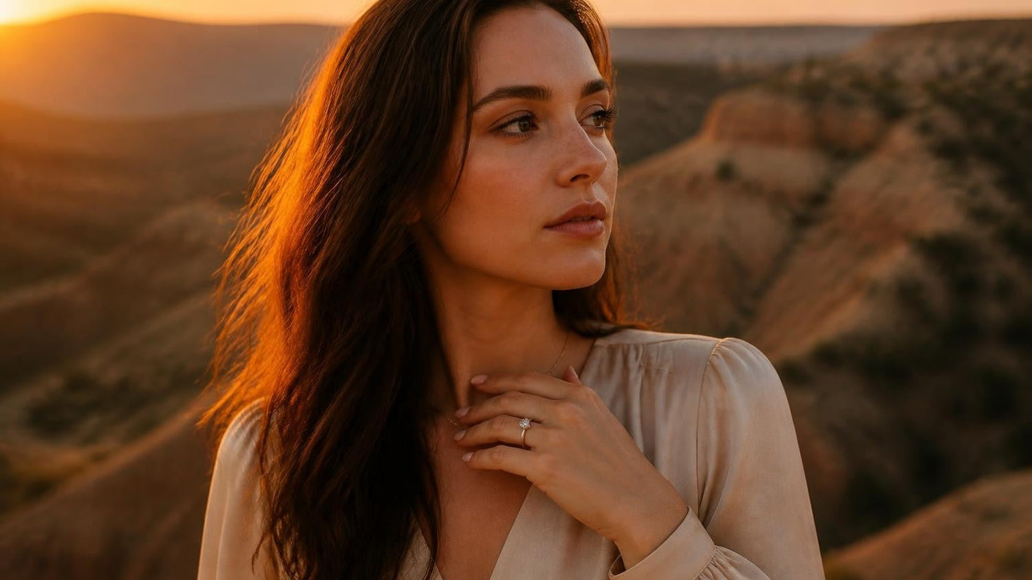 Best engagement rings in Amarillo — elegant woman at Palo Duro Canyon sunset wearing a Satéur Destinée solitaire ring