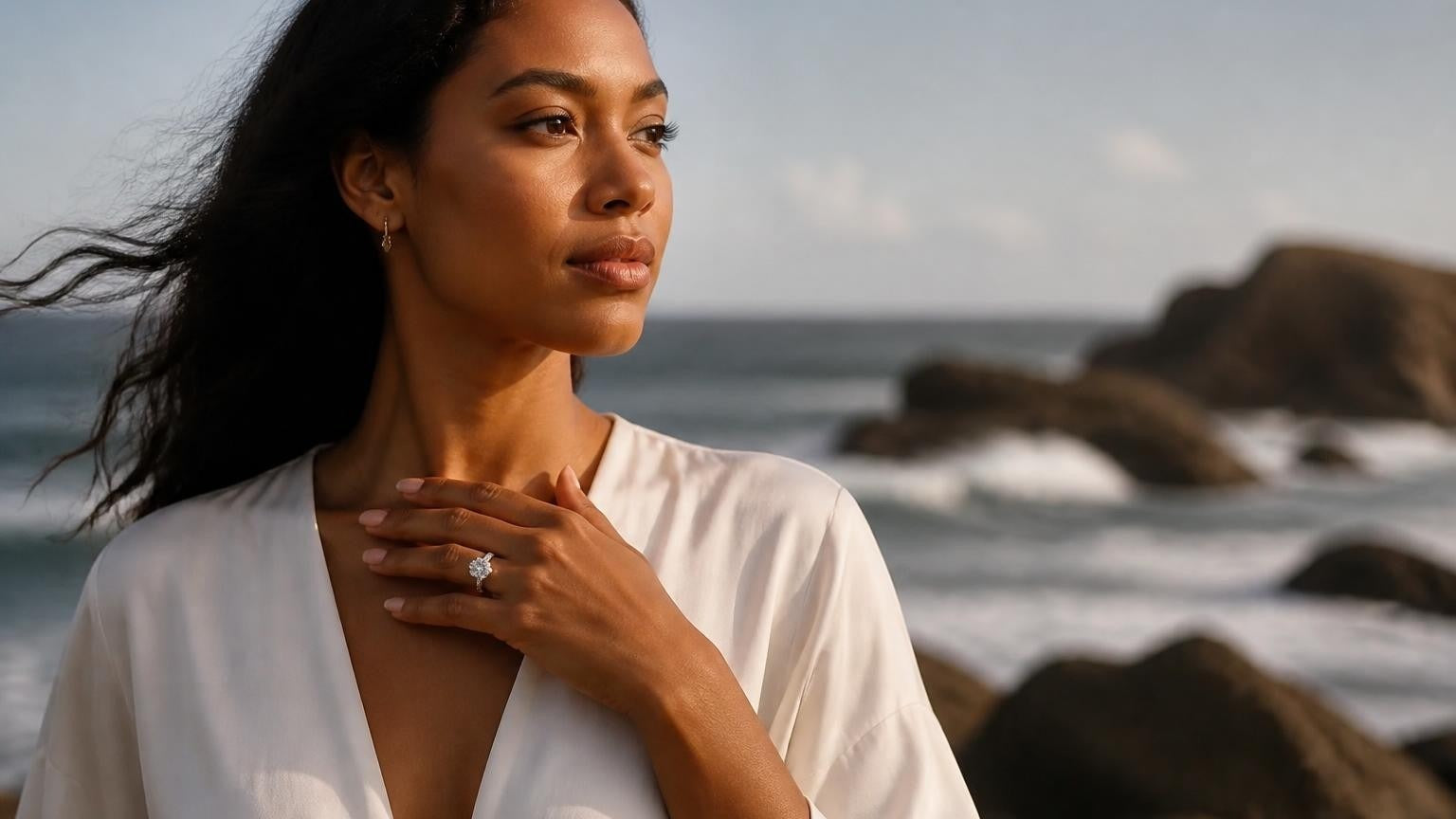 Elegant Barbadian woman wearing Satéur Destinée Ring with Bathsheba Atlantic rock formations behind her