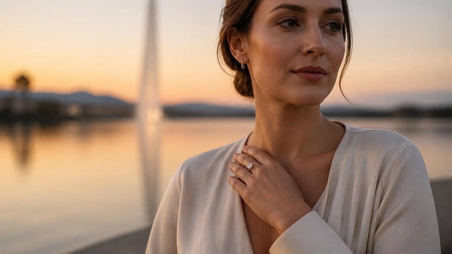 Best engagement rings in Canberra — woman wearing the Satéur Destinée Ring at Lake Burley Griffin at dusk