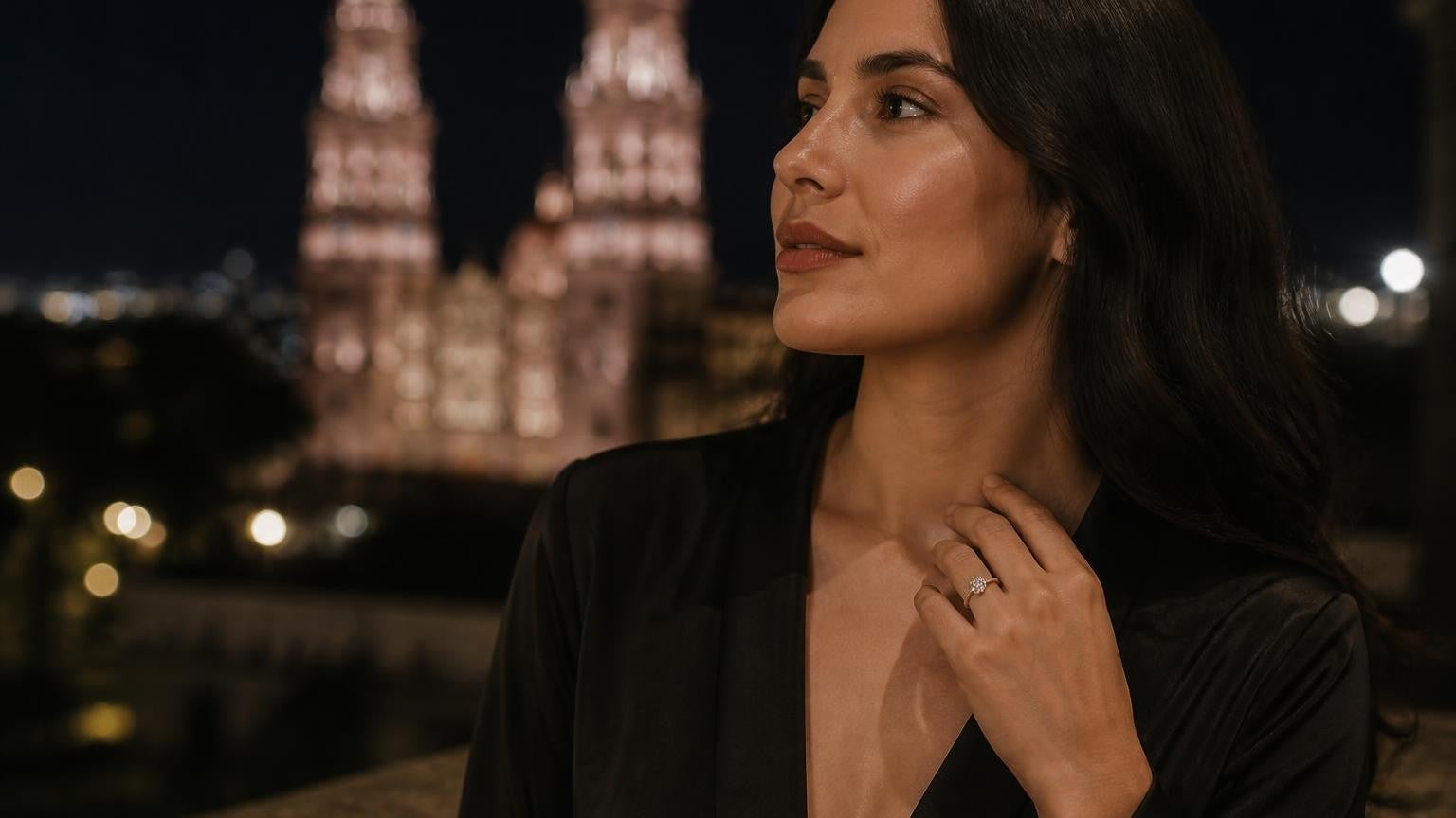 Best engagement rings in Morelia — elegant woman with solitaire ring, Morelia Cathedral twin towers at night