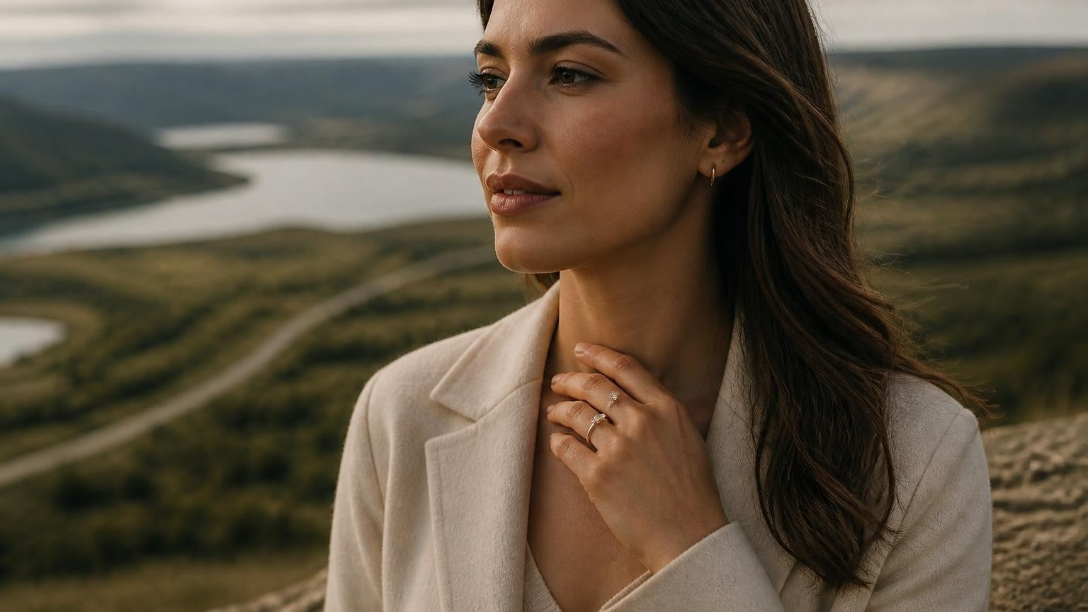 Best engagement rings in Red Deer — elegant Canadian woman with solitaire ring, Red Deer River valley behind