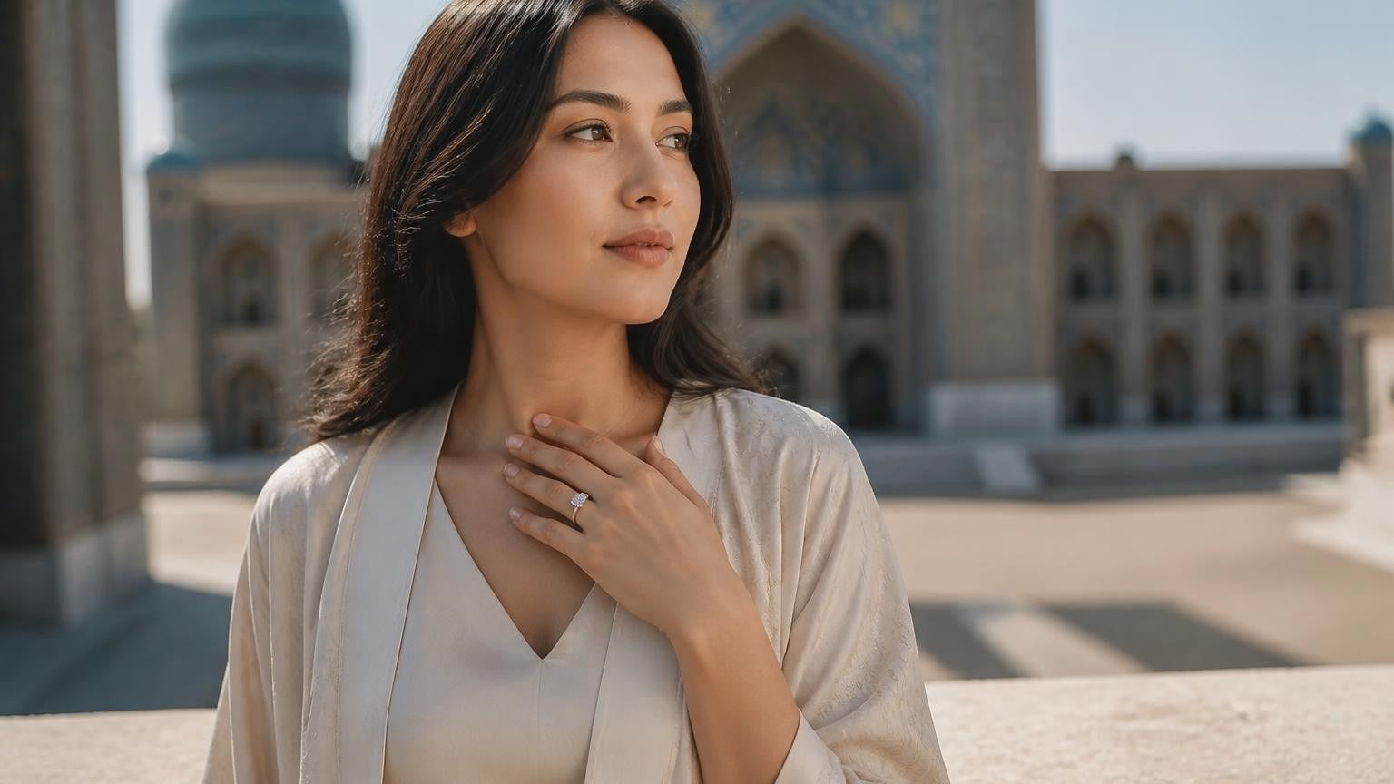 Best engagement rings in Uzbekistan — elegant woman with solitaire ring, Registan Square blurred behind