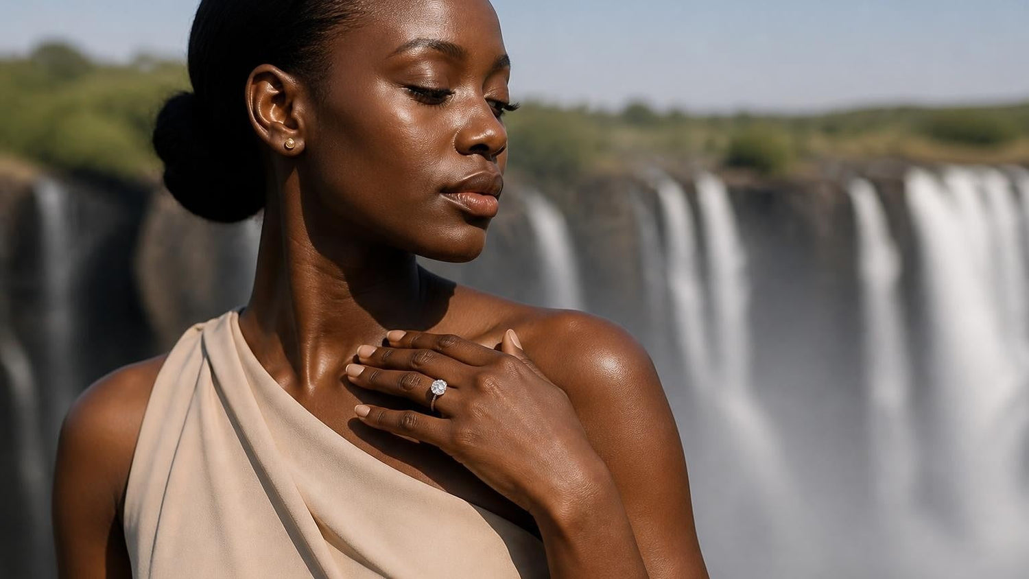 Best engagement rings in Zambia — elegant Zambian woman with Satéur Destinée Ring, Victoria Falls backdrop