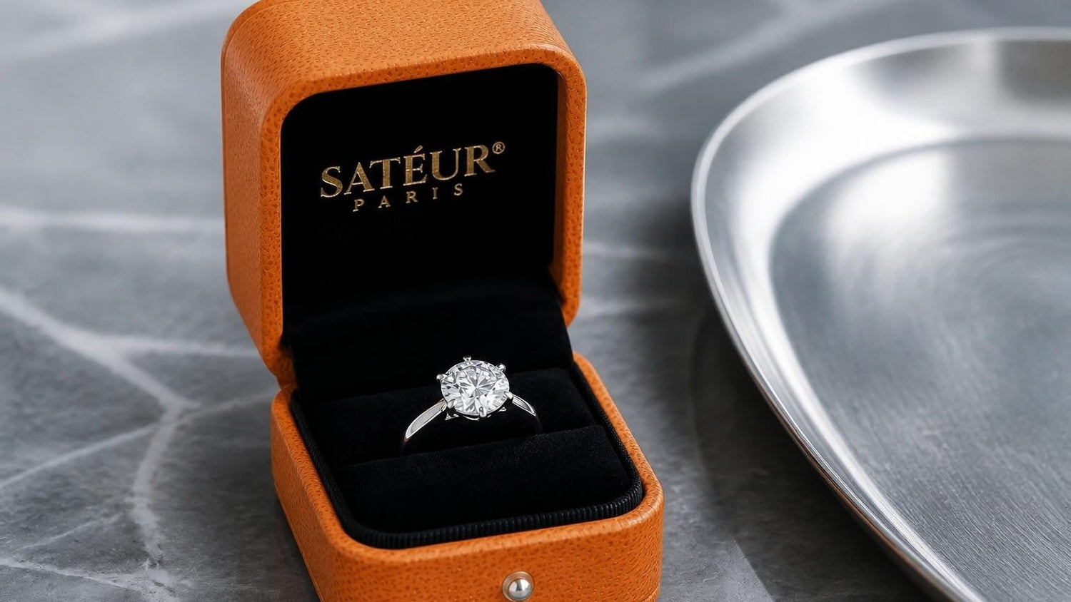 Cubic zirconia sterling silver ring in open Satéur orange box, black velvet interior