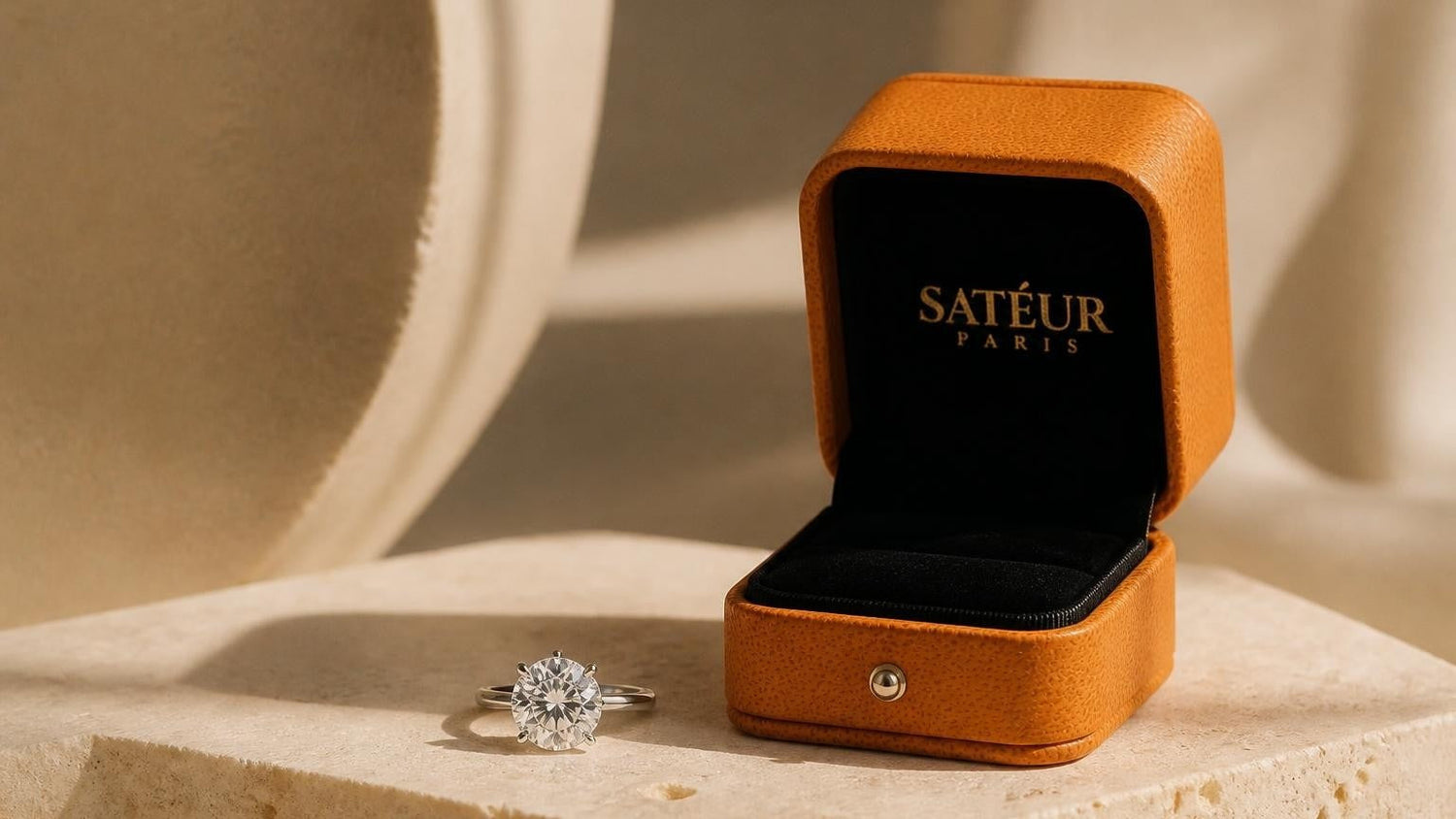 Diamond substitute — Satéur Gems® ring in open orange box on travertine
