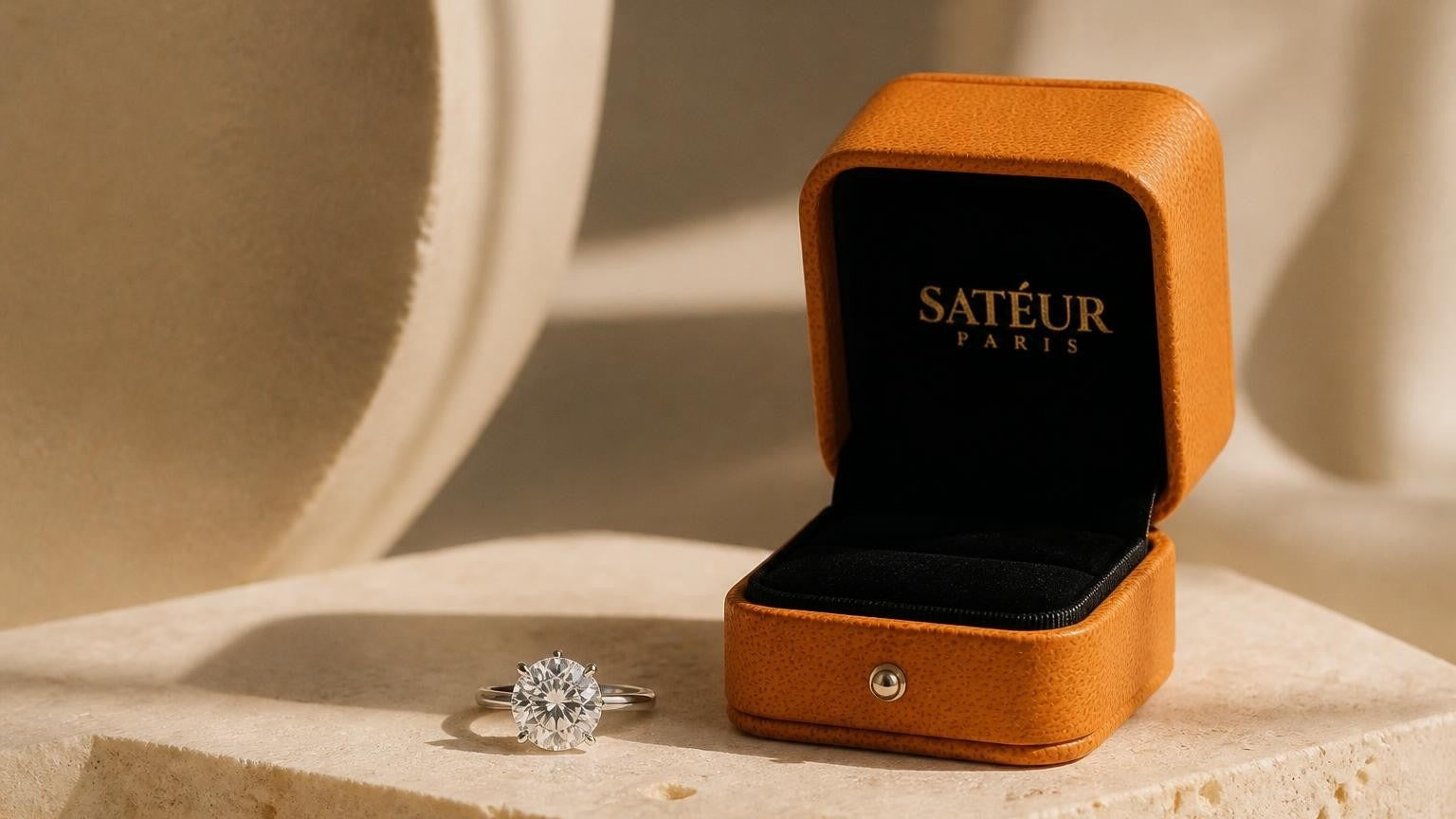 Diamond substitute — Satéur Gems® ring in open orange box on travertine