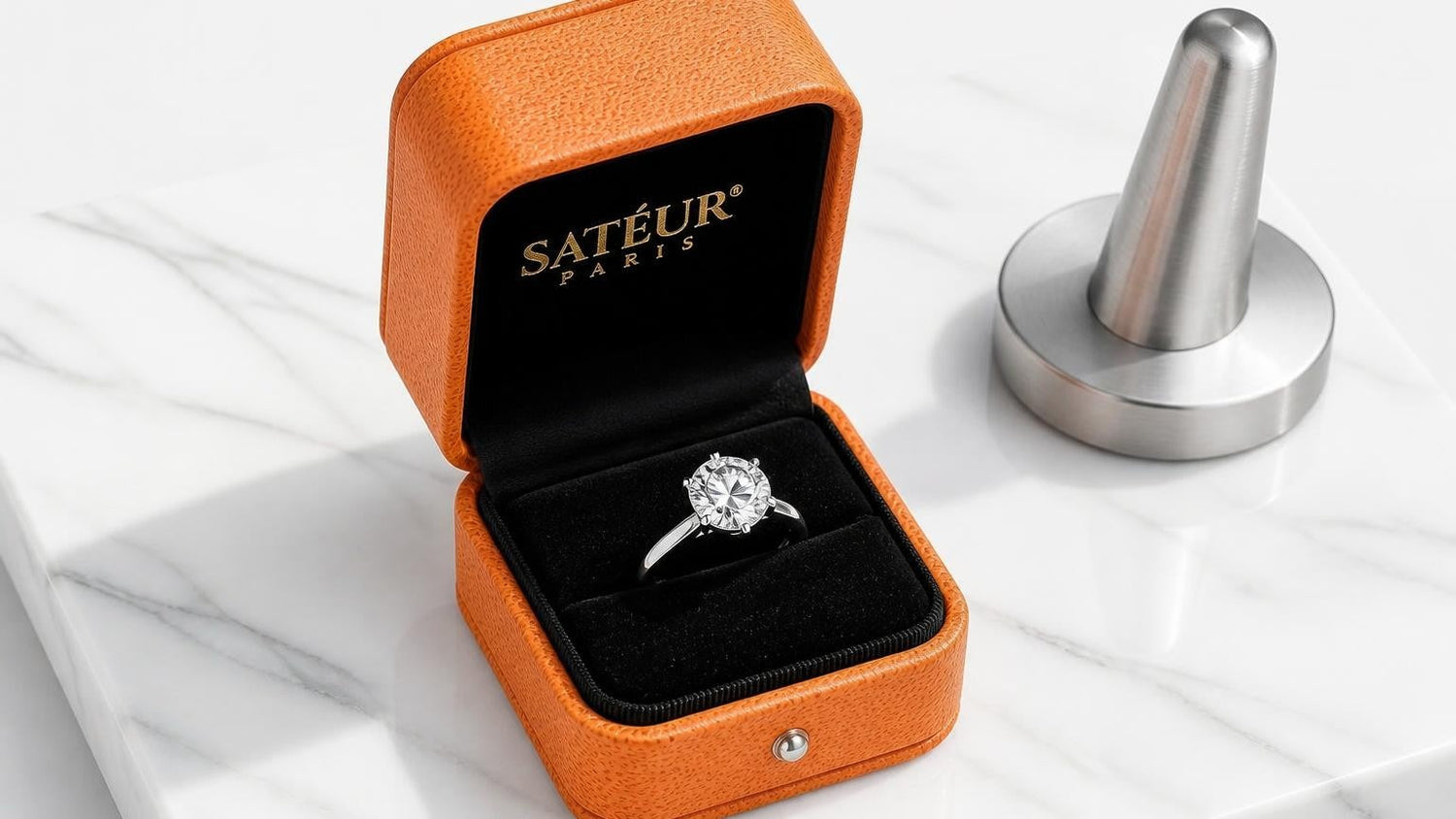 Lab-grown diamond ring in open Satéur box on white Carrara marble