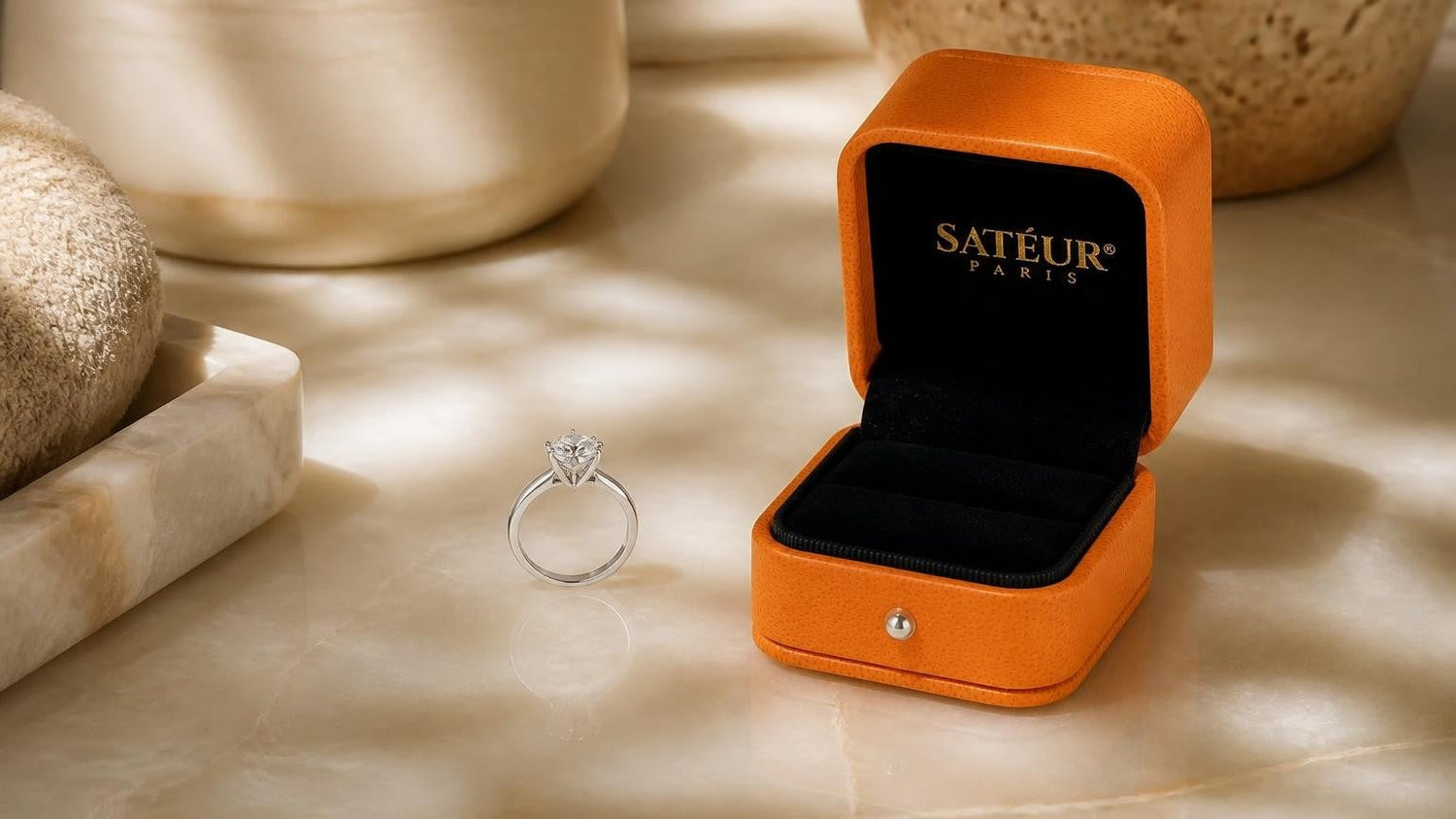 Golden vow ring with open Satéur box on pale onyx vanity