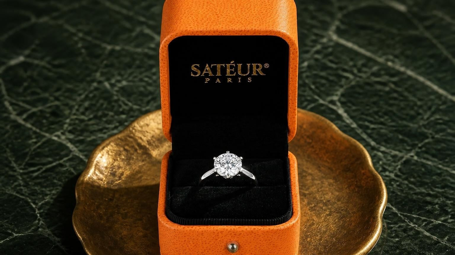 Moissanite ring in open Satéur box on forest-green marble