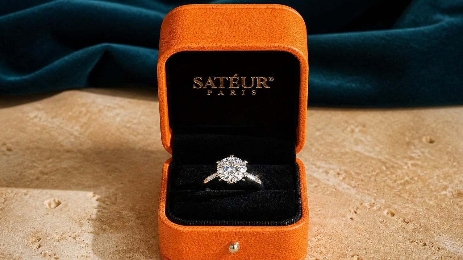 Satéur moissanite ring in open orange Satéur box — simulated diamond vs moissanite comparison guide