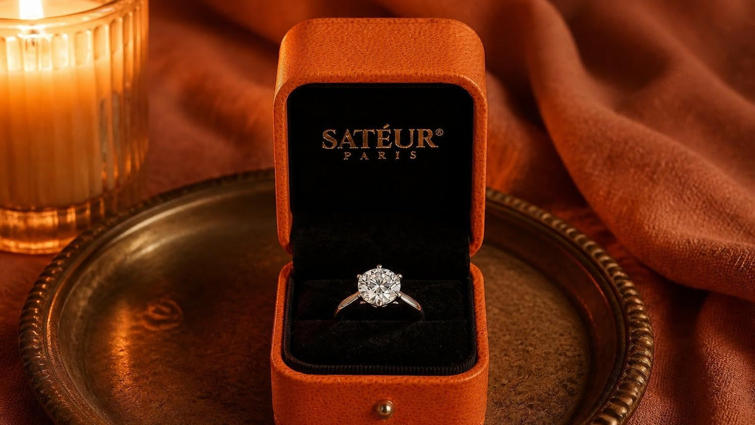 Open orange Satéur ring box with diamond simulant solitaire on black velvet — ring box guide