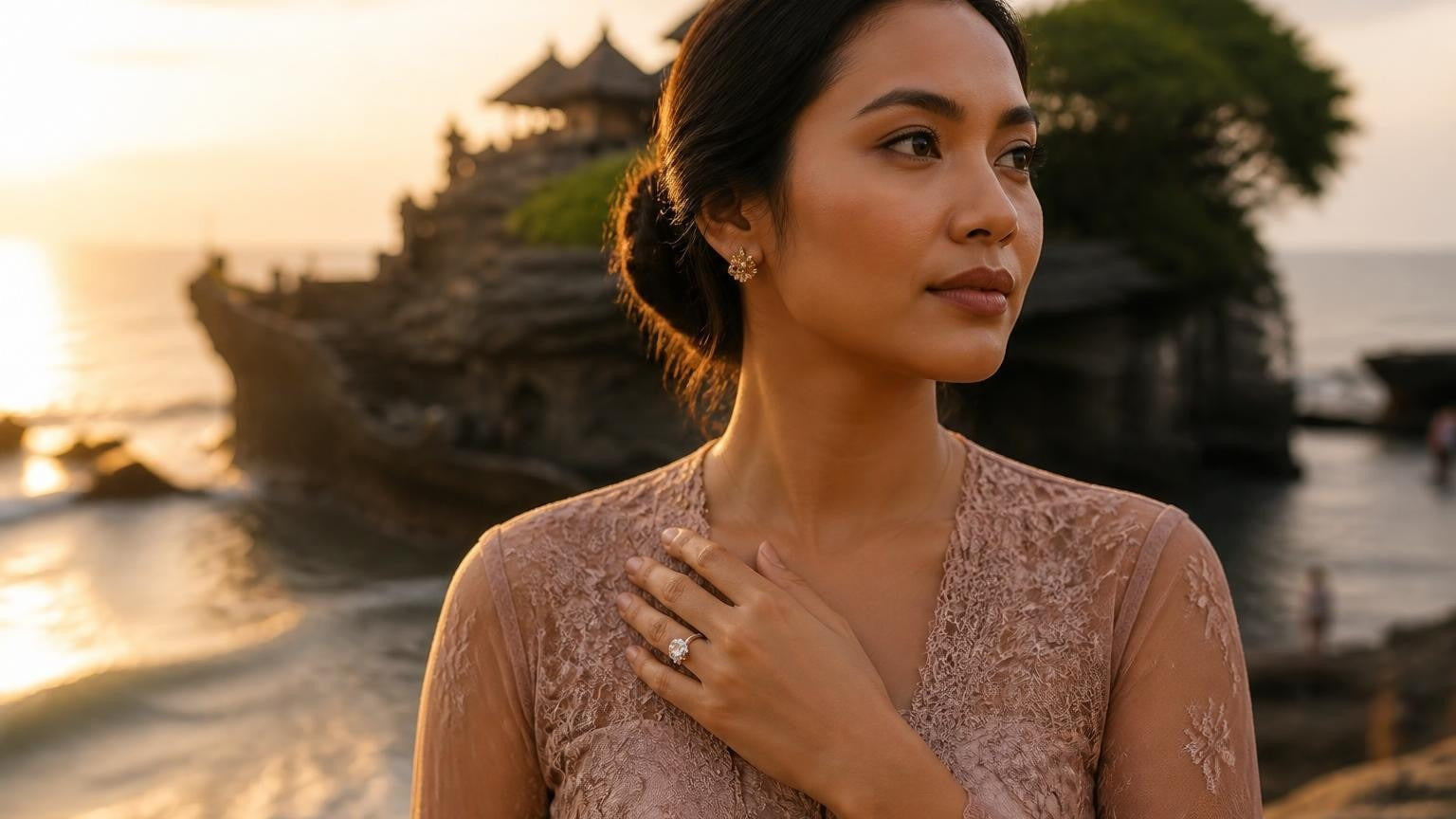 Elegant Balinese woman wearing Satéur Destinée Ring at Tanah Lot sea temple at golden hour
