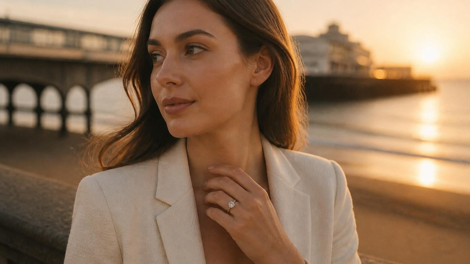 Best engagement rings in Bournemouth — elegant woman with Satéur Destinée Ring™ at Bournemouth Pier at golden hour