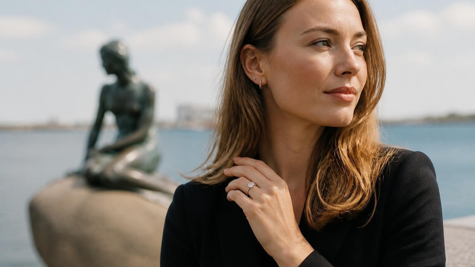 Best engagement rings in Copenhagen — elegant Danish woman with Satéur Destinée Ring at the Little Mermaid statue, Langelinie