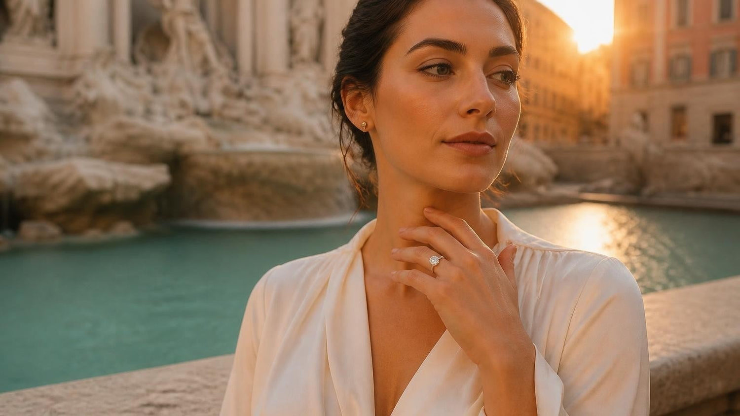 Elegant Italian woman wearing a Satéur Destinée Ring with the Trevi Fountain in Rome at golden hour