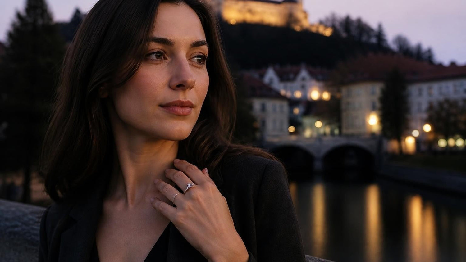 Best engagement rings in Ljubljana — elegant woman with Satéur Destinée ring, Ljubljana Castle at dusk