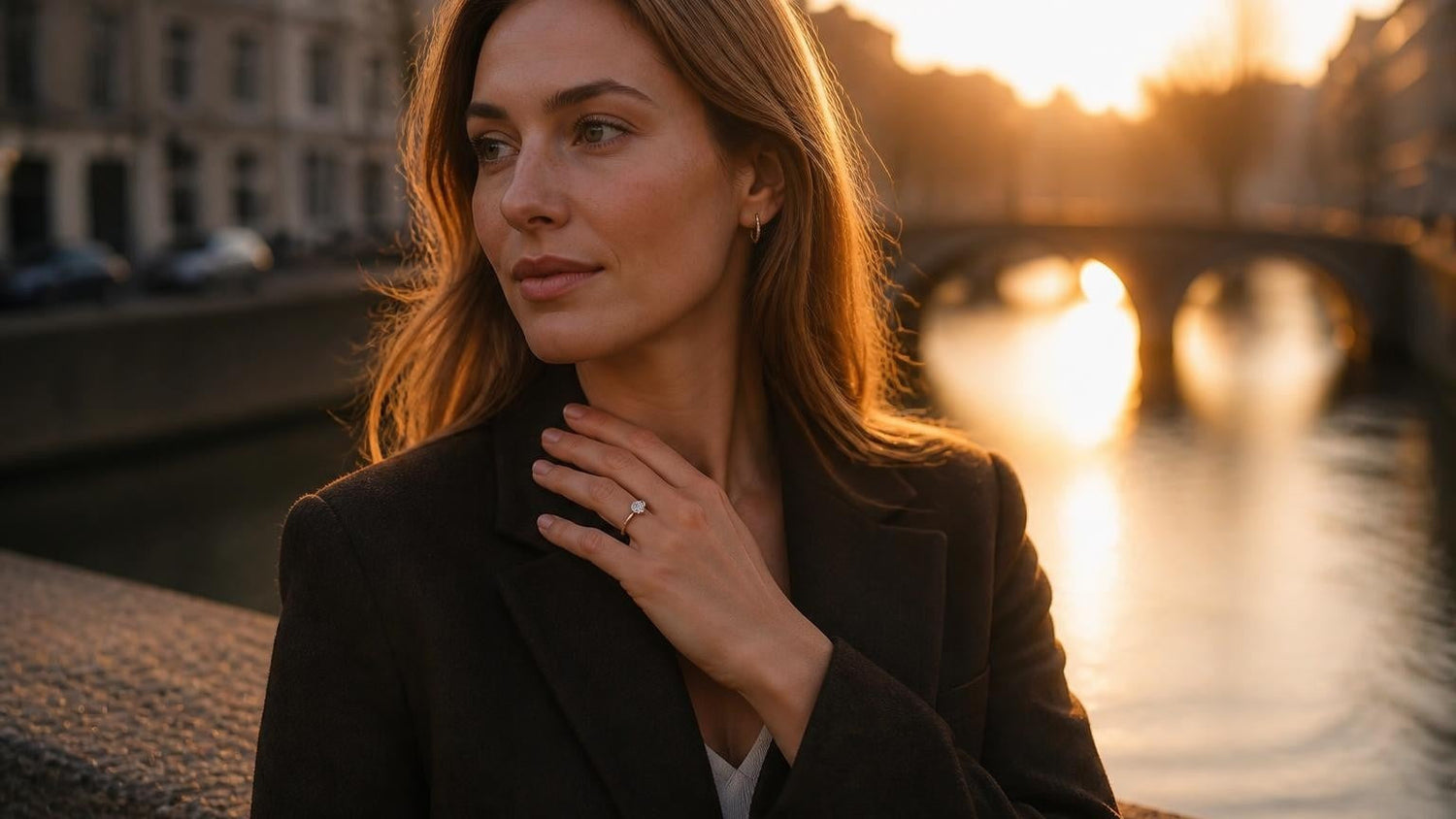 Elegant Dutch woman wearing Satéur Destinée solitaire engagement ring on Amsterdam canal bridge at golden hour