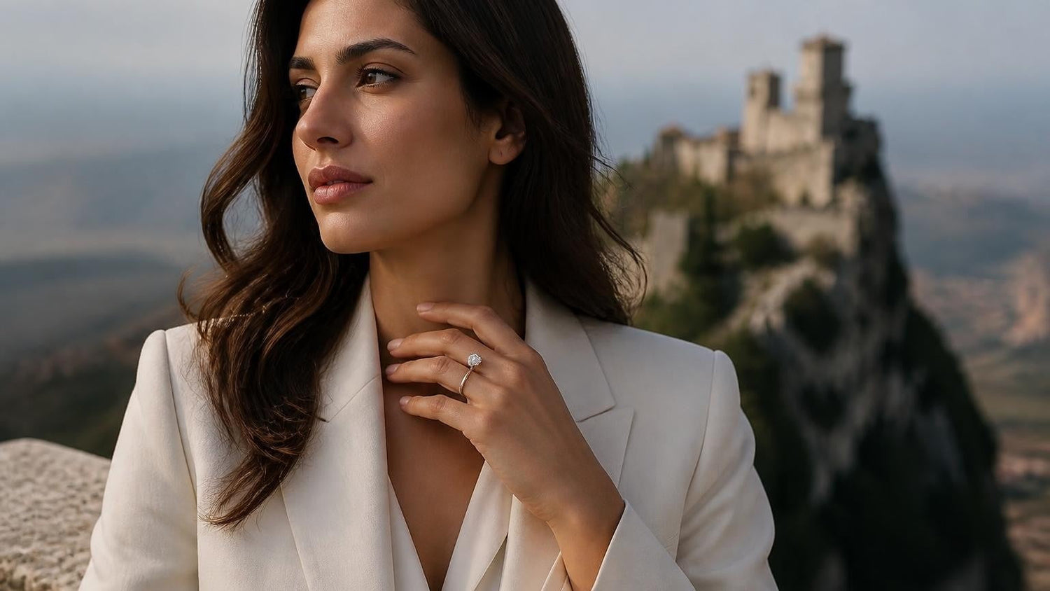 Best engagement rings in San Marino — elegant woman with solitaire ring, Guaita Tower of San Marino behind