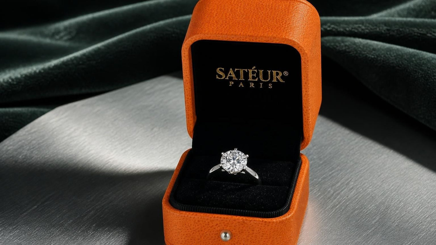 Best men's rings — Satéur ring in open orange box, brushed titanium surface, dark green velvet