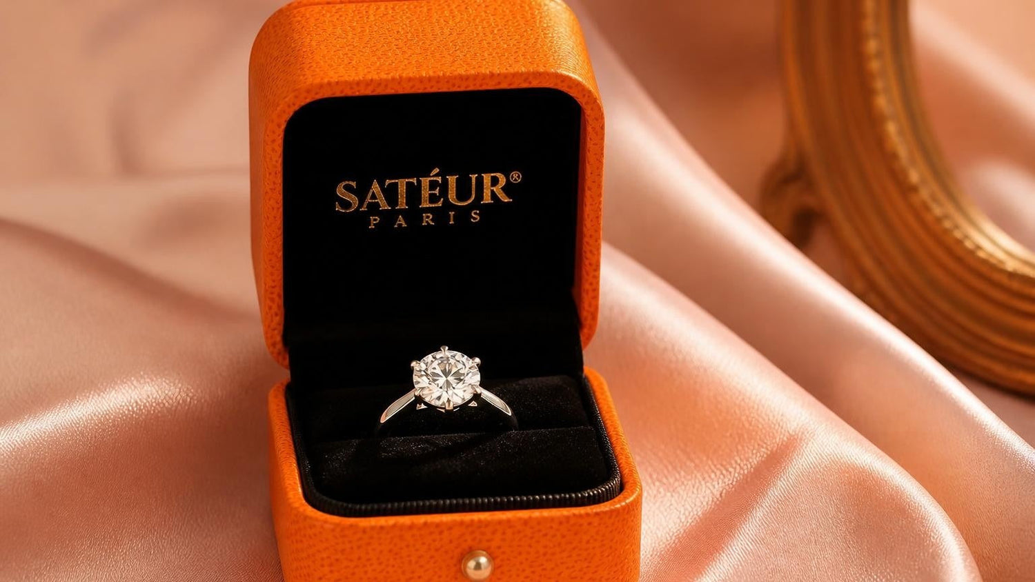 Satéur engagement ring in open orange box — engagement ring budget guide