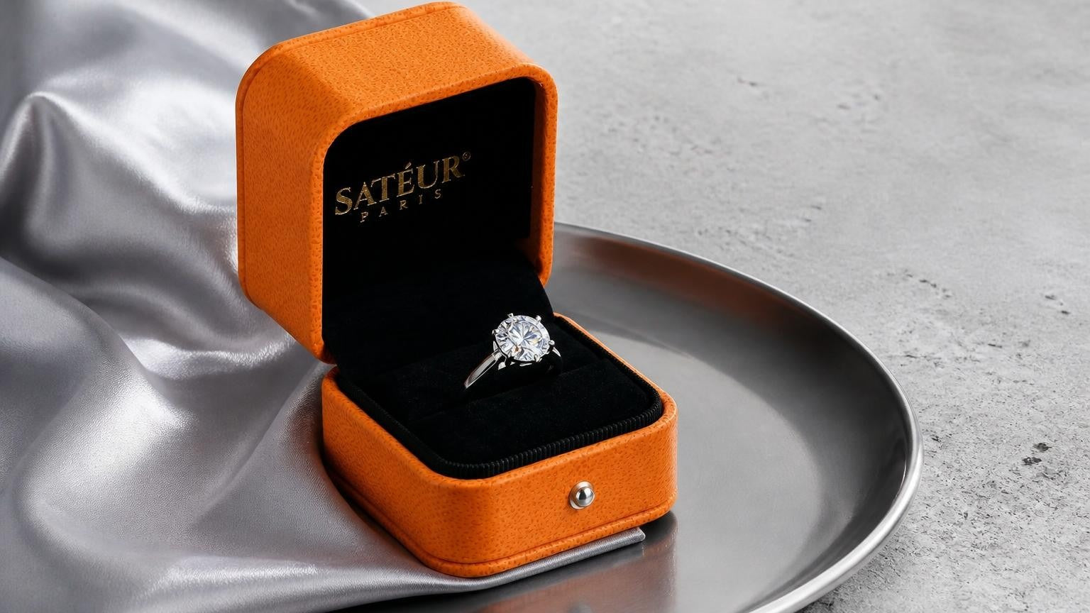 Is moissanite a fake diamond — open Satéur box with moissanite ring showing vivid fire