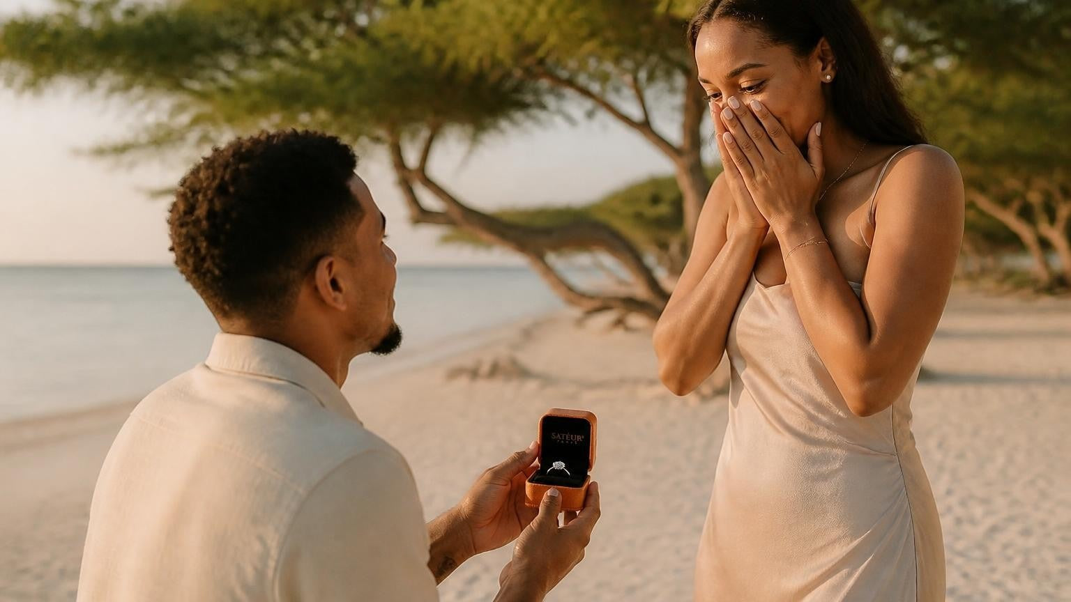 Marriage proposal in Aruba with the Satéur Destinée Ring — golden-hour moment beneath the fofoti trees of Eagle Beach